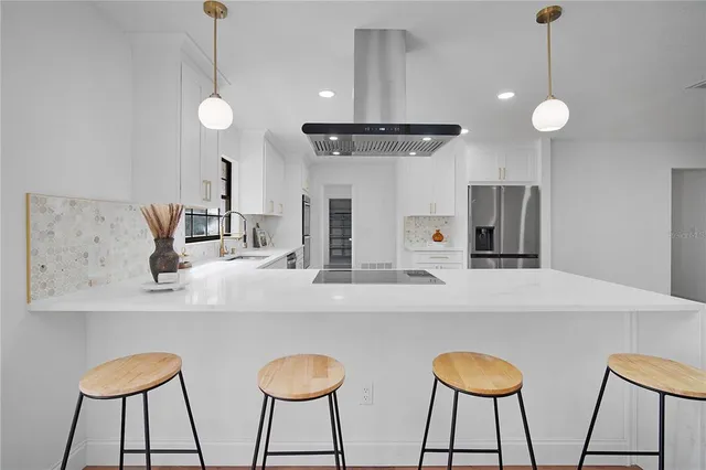 a living room with furniture a fireplace and a floor to ceiling window