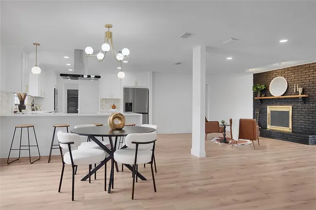 a bedroom with a bed and a table with wooden floor