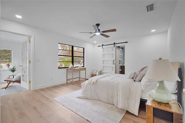 a bedroom with a bed and a chandelier