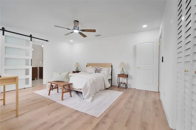 a spacious bathroom with a double vanity sink a toilet and a shower