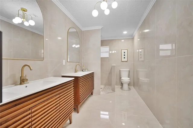 a bathroom with a sink toilet vanity and shower