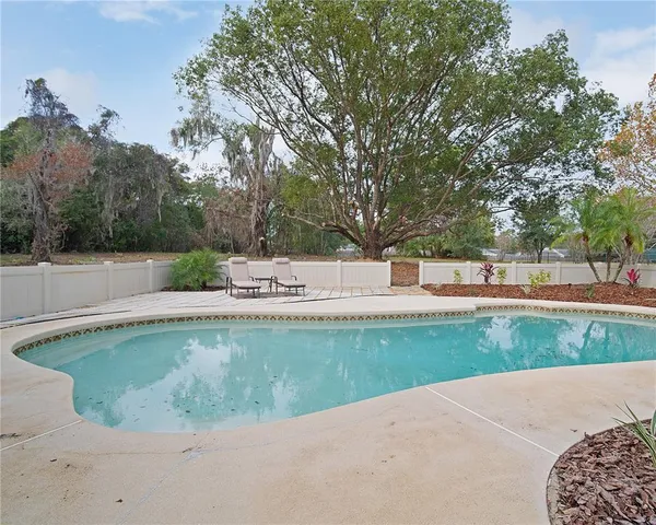 a view of a swimming pool with an outdoor seating