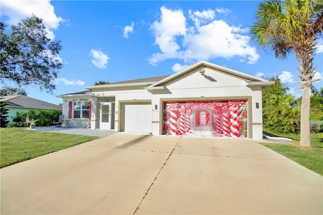 a view of a house with a yard and garage