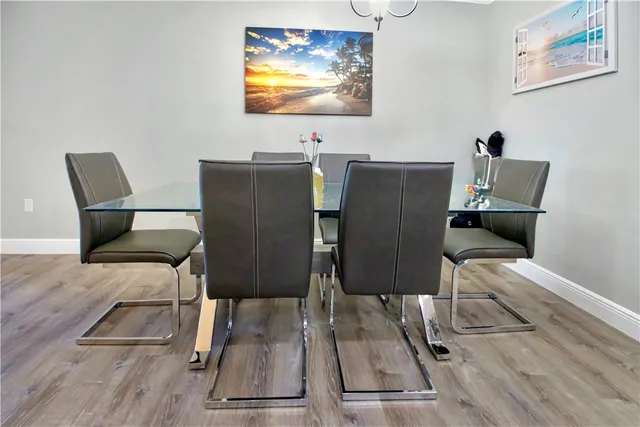 a view of a dining room with furniture wooden floor and chandelier