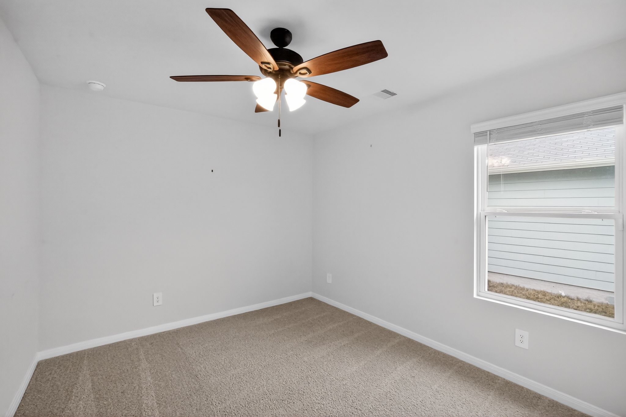 206 Addison Place Lockhart, TX 78644 - Photo 19 of 25 an empty room with a window and a fan
