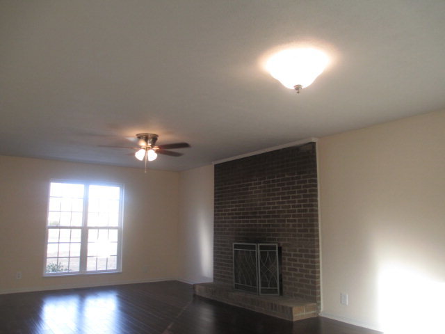 6940 Columbus Road Lizella, GA 31052 - Photo 3 of 14 wooden floor in an empty room with a window