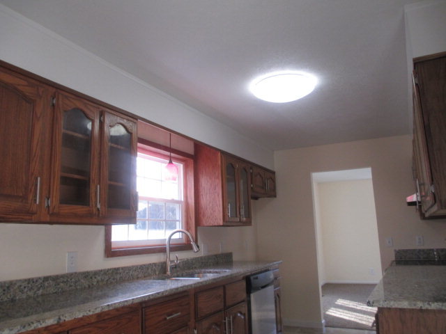 6940 Columbus Road Lizella, GA 31052 - Photo 5 of 14 a kitchen with a sink cabinets and window