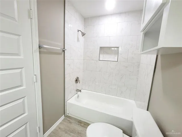 a bathroom with a toilet and bathtub