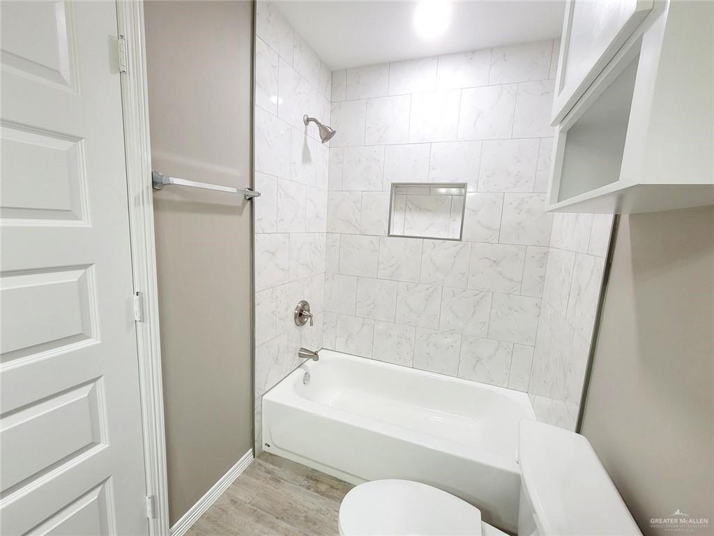 3808 Las Vistas Lane, Unit 1 Weslaco, TX 78596 - Photo 17 of 20 a bathroom with a toilet and bathtub