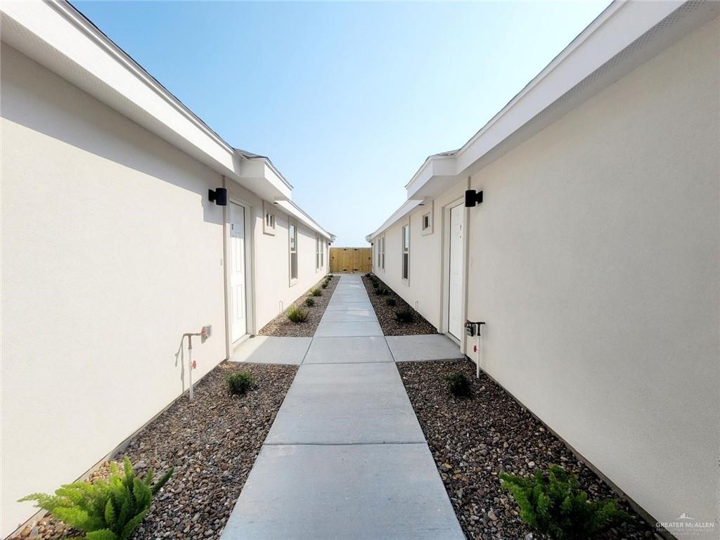 3808 Las Vistas Lane, Unit 1 Weslaco, TX 78596 - Photo 4 of 20 a view of a pathway with white walls