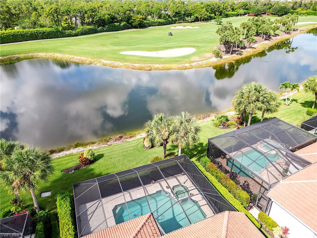 9156 Spring Run Boulevard Estero, FL 34135 - Photo 31 of 34 a view of a swimming pool with a yard