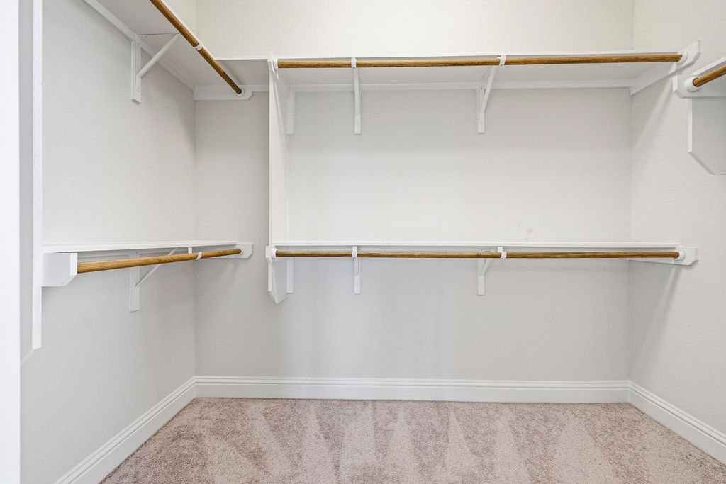 2032 Base Burner Path Leander, TX 78641 - Photo 31 of 34 Walk-in closet featuring white shelving and hanging rods