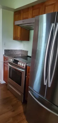 a stove top oven sitting inside of a kitchen