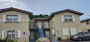 a view of a house with a car parked front of it