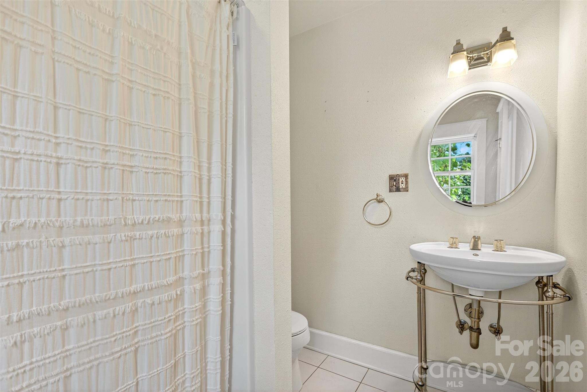 160 East Howard Street Tryon, NC 28782 - Photo 22 of 48 a bathroom with a sink a mirror and a toilet