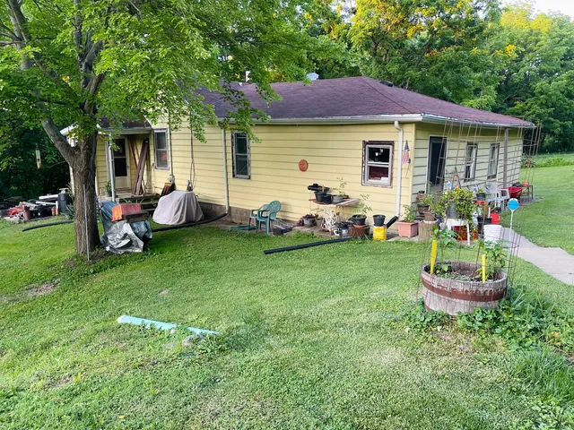 a front view of a house with a garden and patio