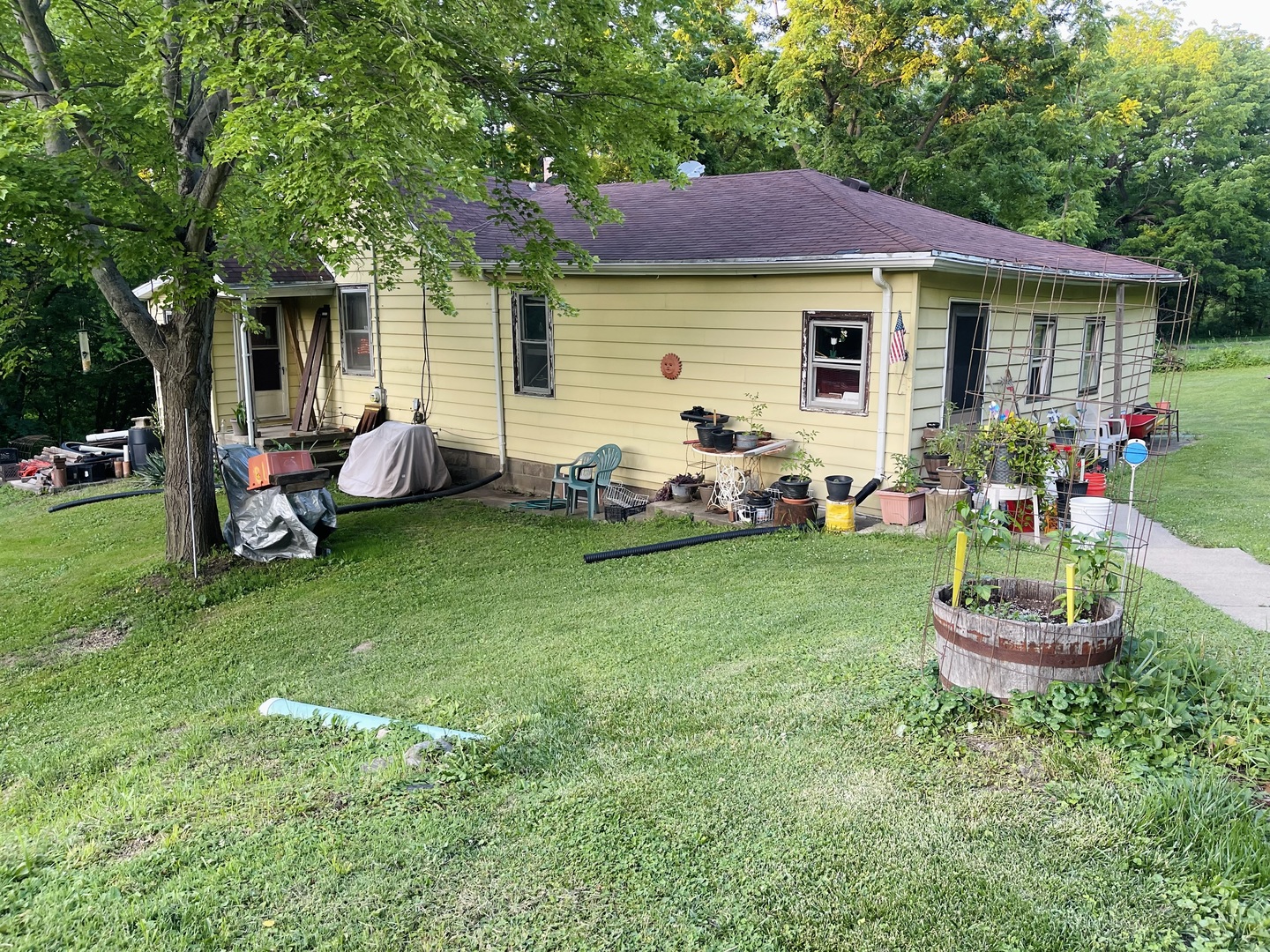 a front view of a house with a garden and patio