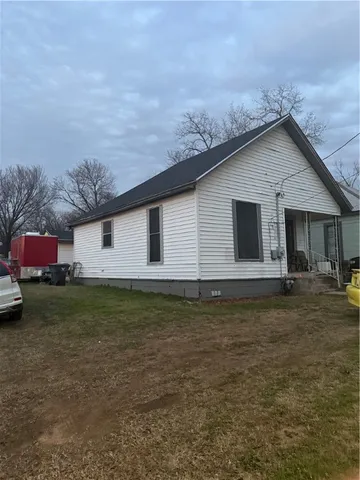 a backyard of a house with table and chairs