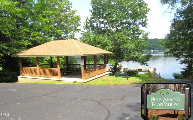 a view of swimming pool with lawn chairs under an umbrella