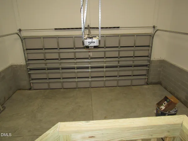 a view of swimming pool with lawn chairs under an umbrella