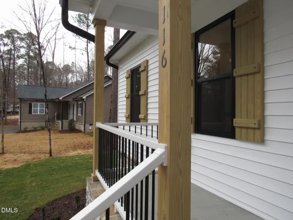 a view of a house with backyard and porch