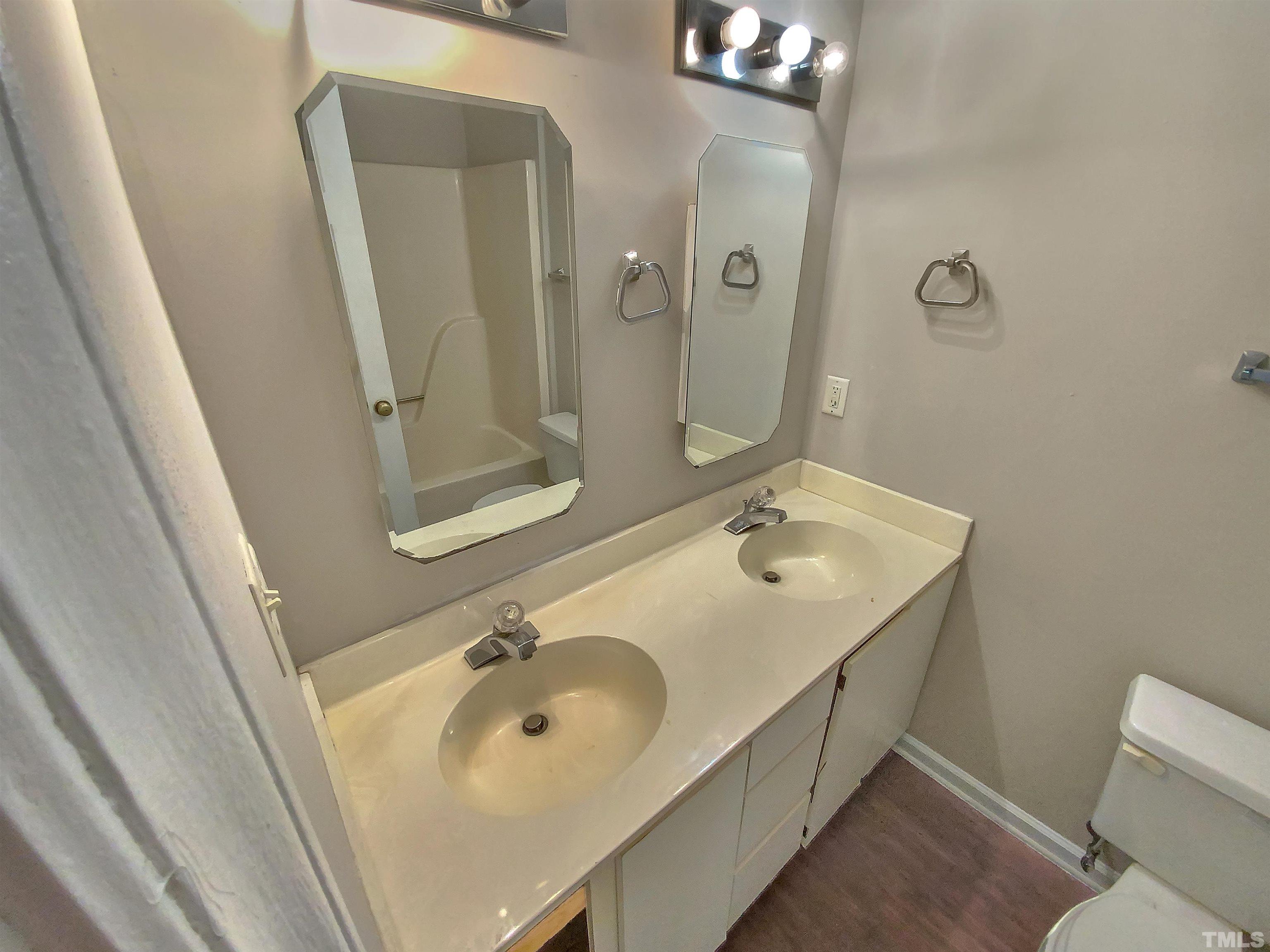 7508 Mine Shaft Road Raleigh, NC 27615 - Photo 13 of 18 a bathroom with a sink and mirror with toilet