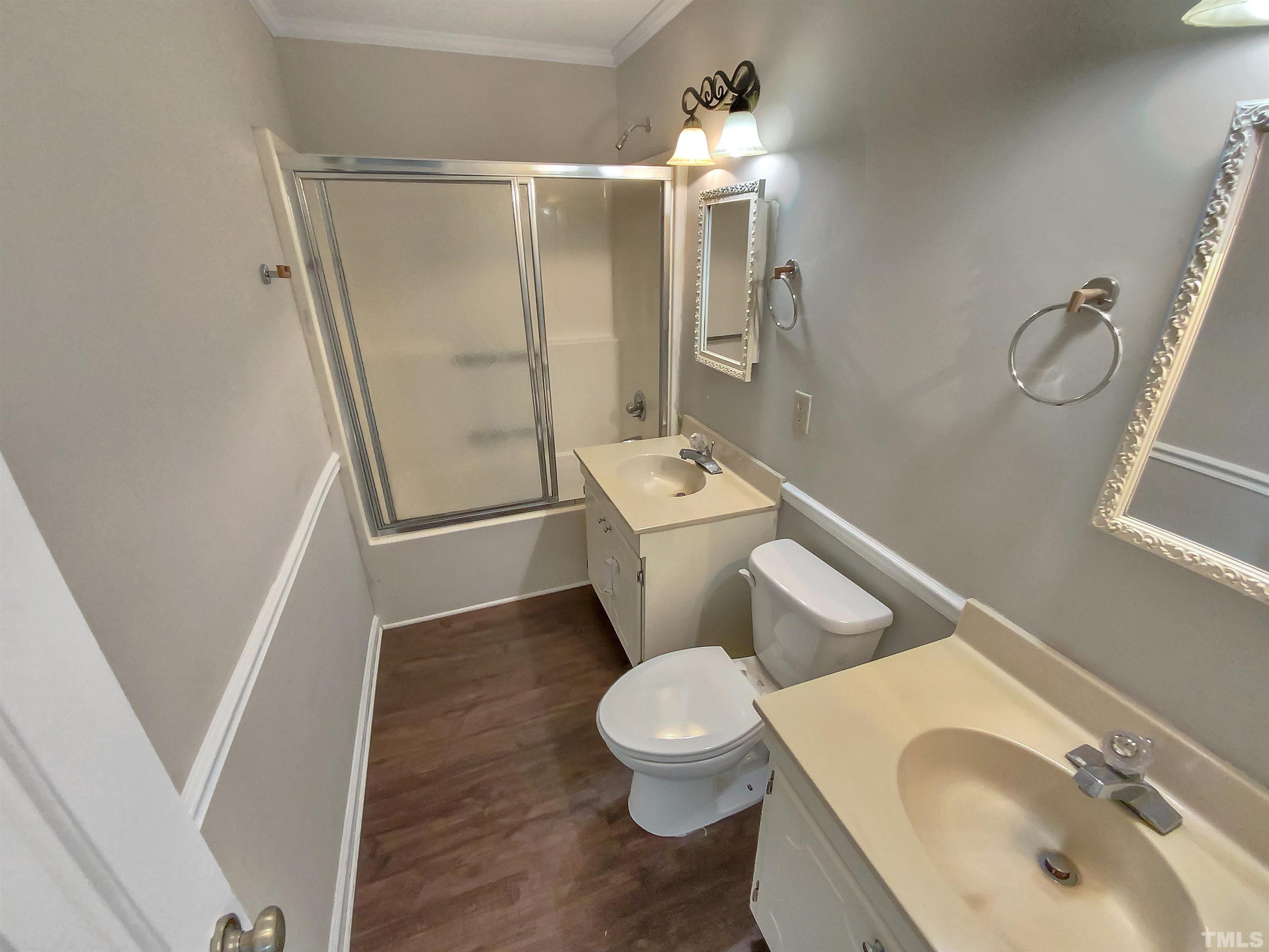 7508 Mine Shaft Road Raleigh, NC 27615 - Photo 14 of 18 a white toilet sitting next to a bathroom sink