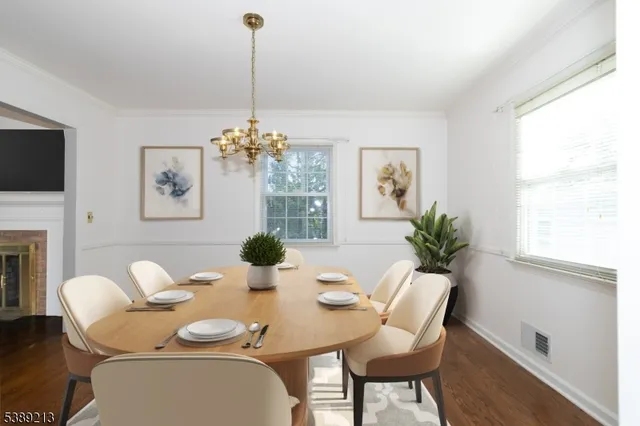 a dining room with furniture a large window and wooden floor