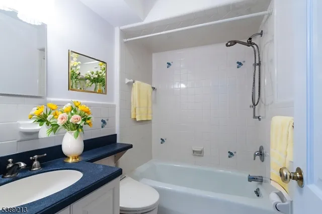 a bath room with a sink mirror and a bath tub
