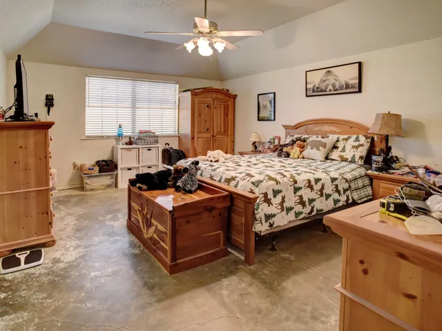 a bed room with a bed and a television