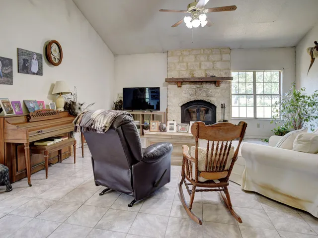 a living room with furniture and a bookshelf