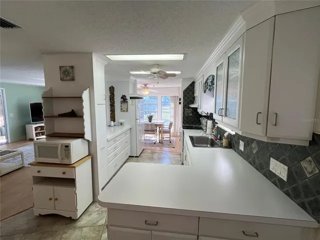 a kitchen with sink refrigerator and stove