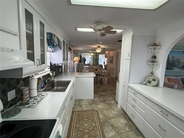 a room with lots of wooden furniture and glass door