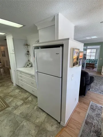a kitchen with refrigerator and car
