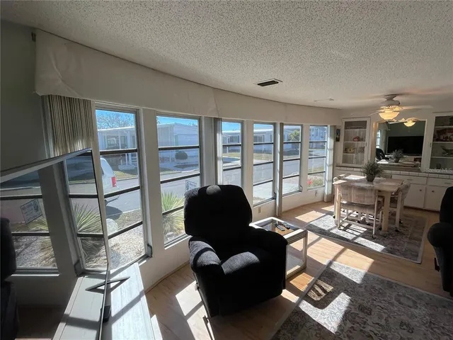 a living room with furniture and a floor to ceiling window