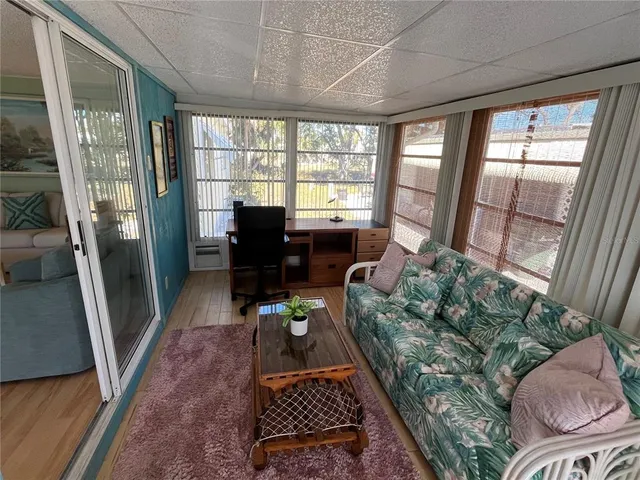 a living room with furniture and a floor to ceiling window