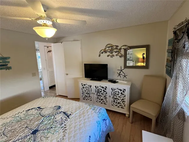 a bedroom with a bed and a television