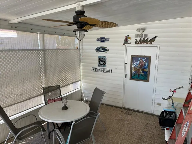 a view of a dining room with furniture and a chandelier