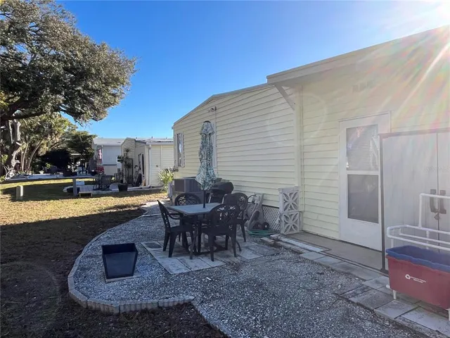 a view of a house with swimming pool and sitting area