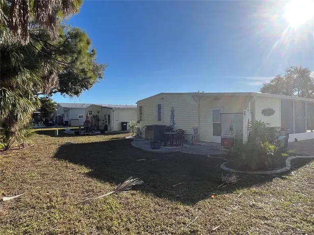 a view of a house with backyard and lake view