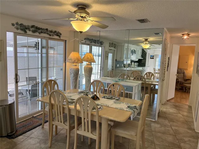 a view of a dining room with furniture and chandelier