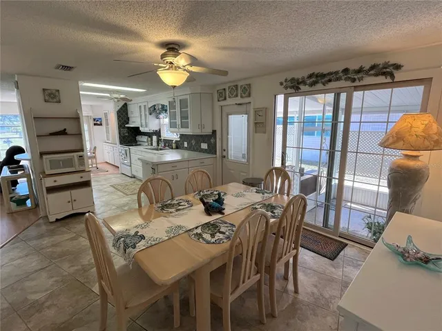 a view of a dining room with furniture and a chandelier