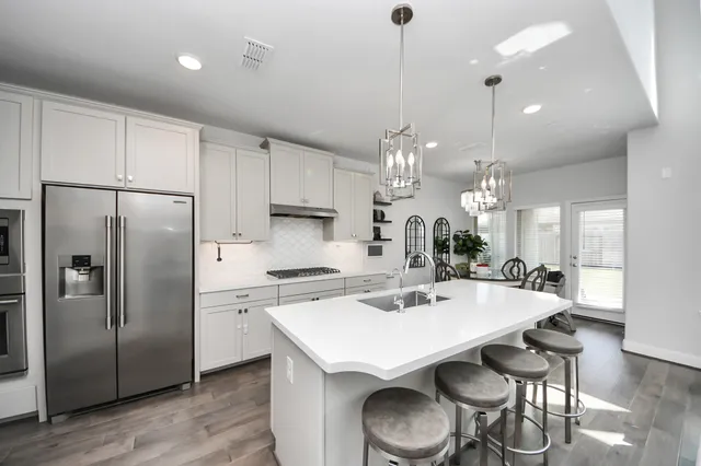a living room with furniture wooden floor and a chandelier