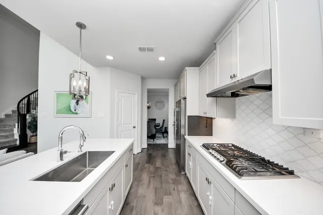 a bedroom with a bed a table and chair