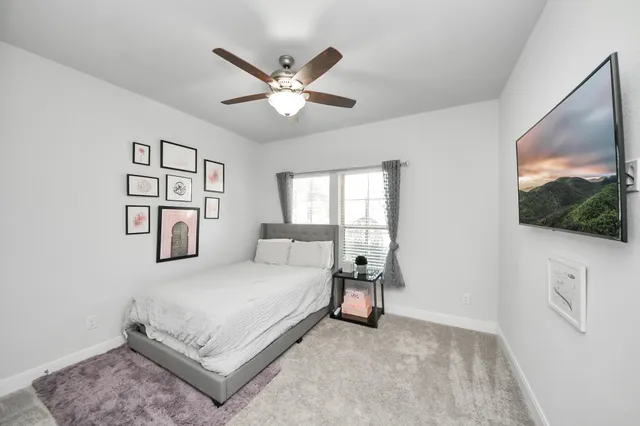a bedroom with a large bed and a chandelier