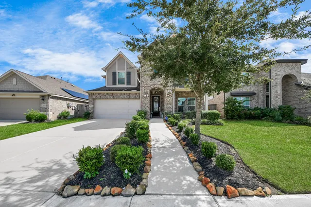 a front view of a house with a yard and a garage