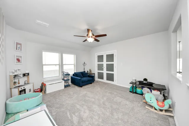 a bedroom with furniture and a window