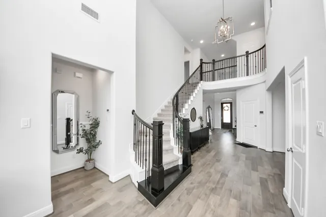 a view of a hallway with windows and wooden floor