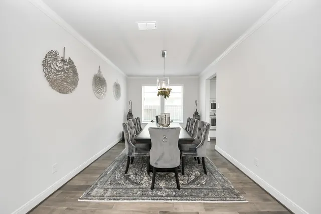 a view of a dining room with furniture and window