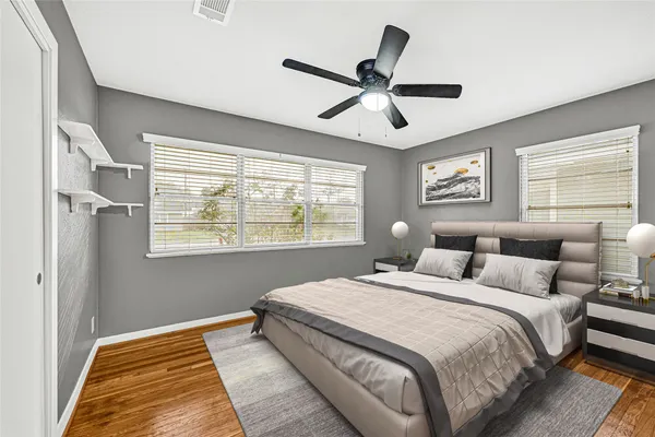 a bedroom with a large bed and a window